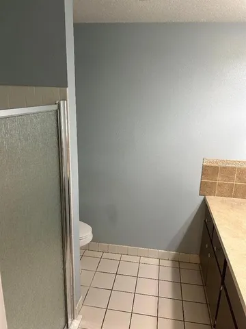 a bathroom with a granite countertop sink and a vanity