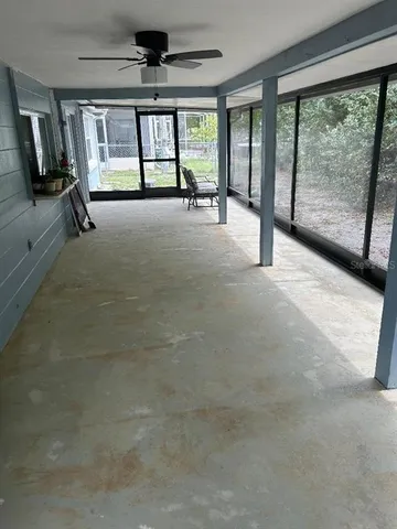 a view of an empty room with a fireplace and a large window