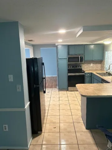 a kitchen with stainless steel appliances a refrigerator and a sink
