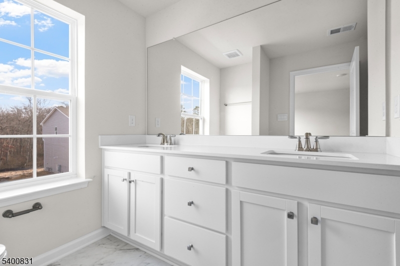 175 Mantoloking Drive Jackson, NJ 08527 - Photo 19 of 25 a bathroom with a sink and a mirror