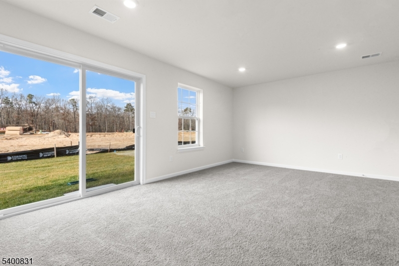 175 Mantoloking Drive Jackson, NJ 08527 - Photo 22 of 25 a view of an empty room with a floor to ceiling window and a lake view