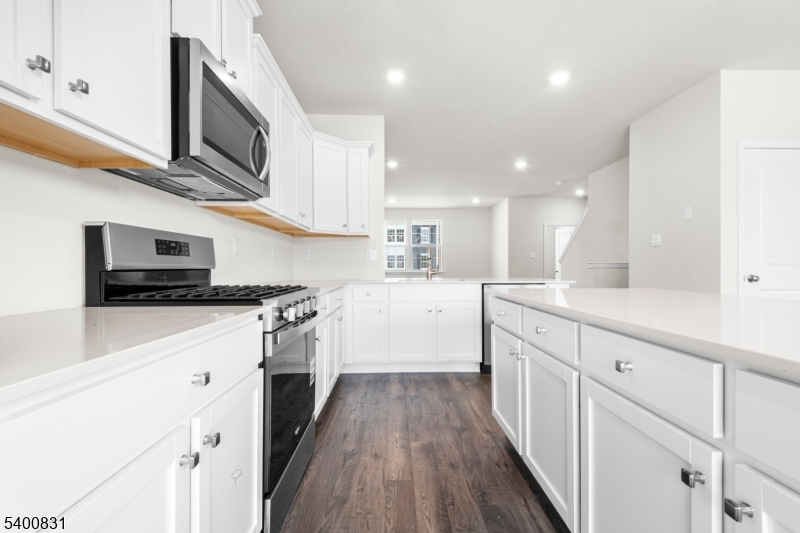 175 Mantoloking Drive Jackson, NJ 08527 - Photo 5 of 25 a kitchen with stainless steel appliances kitchen island granite countertop a sink a stove top oven a counter space and cabinets