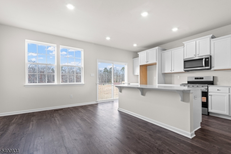 175 Mantoloking Drive Jackson, NJ 08527 - Photo 6 of 25 a kitchen with stainless steel appliances granite countertop a stove a sink a refrigerator white cabinets and a large window