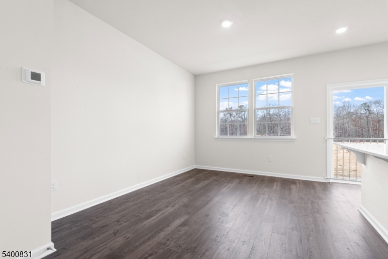 175 Mantoloking Drive Jackson, NJ 08527 - Photo 7 of 25 an empty room with wooden floor and windows