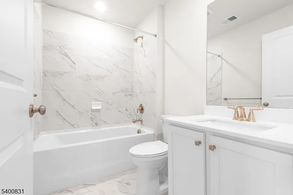 a bathroom with a sink a toilet and a bathtub