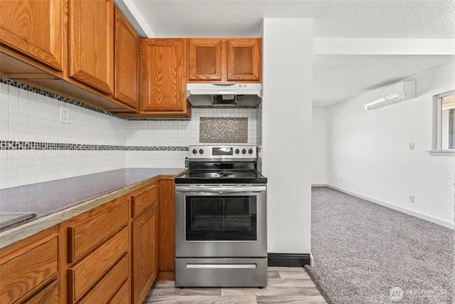a kitchen with granite countertop a stove and a sink