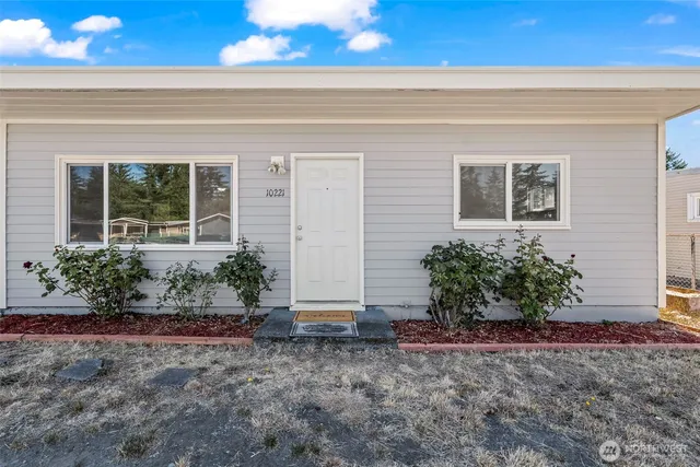 a view of a house with potted plants