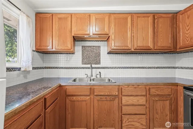 a kitchen with stainless steel appliances granite countertop a sink and cabinets
