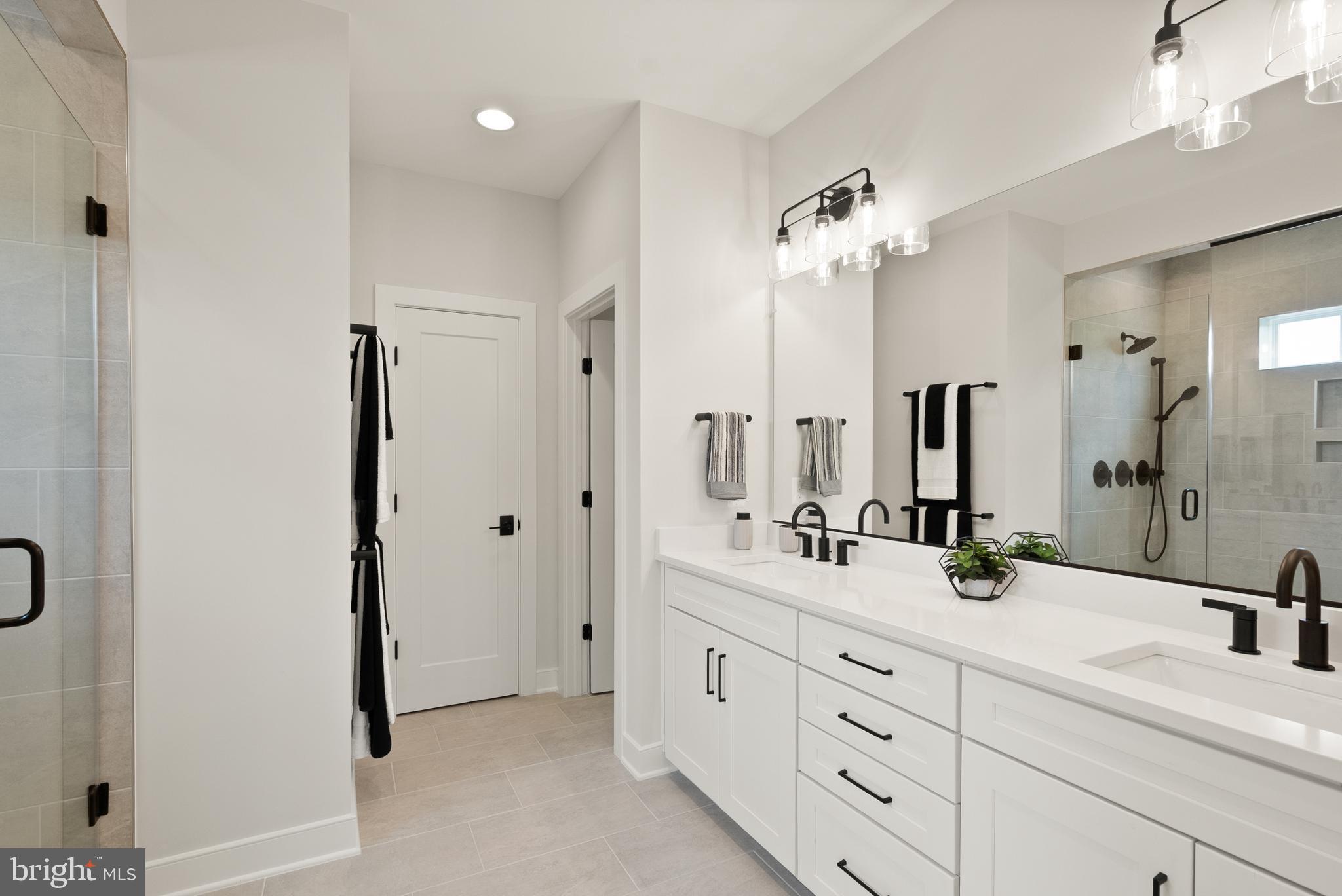 1212 Drake Street Southwest Vienna, VA 22180 - Photo 47 of 84 a bathroom with a double vanity sink and a mirror