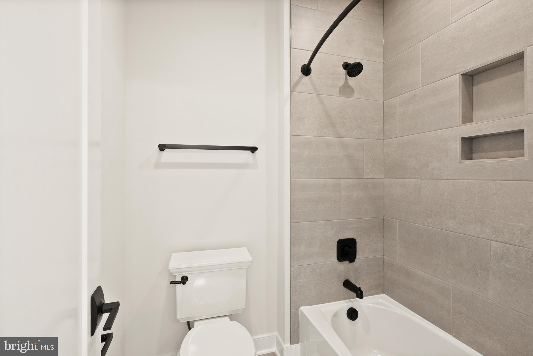 1212 Drake Street Southwest Vienna, VA 22180 - Photo 56 of 84 a bathroom with a bathtub a toilet and a shower