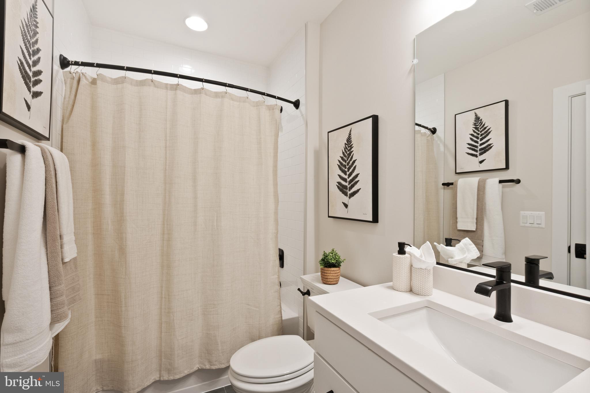 1212 Drake Street Southwest Vienna, VA 22180 - Photo 83 of 84 a bathroom with a sink a toilet and shower curtain