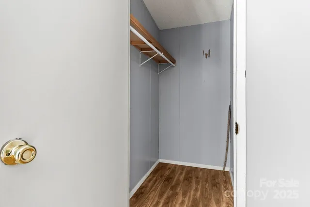 a view of a room with wooden floor