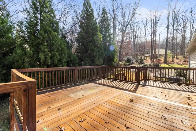 a view of balcony with wooden floor and fence