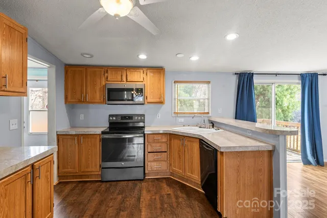 a kitchen with granite countertop a stove and a sink