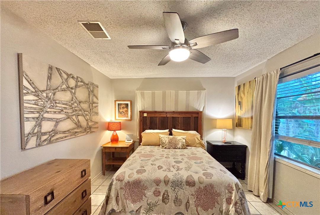 208 Washington Boulevard Port O'Connor, TX 77982 - Photo 21 of 47 a bed room with a bed and a window