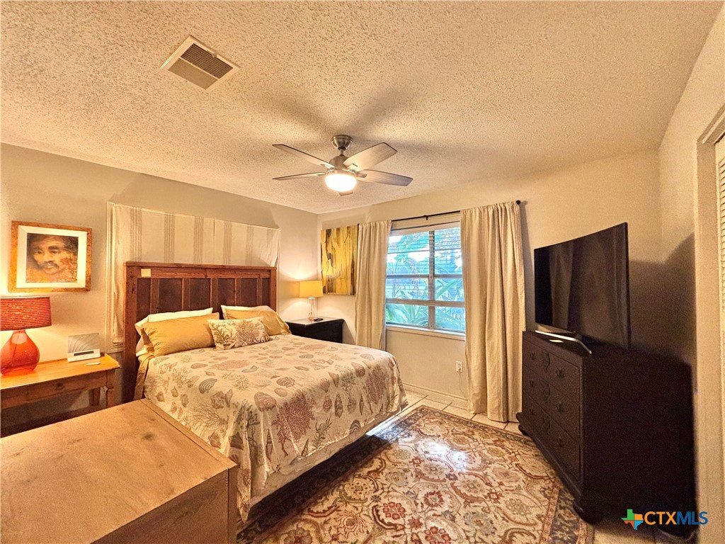 208 Washington Boulevard Port O'Connor, TX 77982 - Photo 22 of 47 a bedroom with double bed and a window