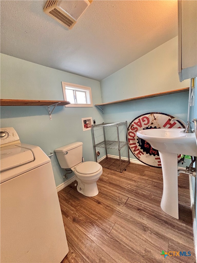 208 Washington Boulevard Port O'Connor, TX 77982 - Photo 38 of 47 a living room with furniture a rug and a toilet
