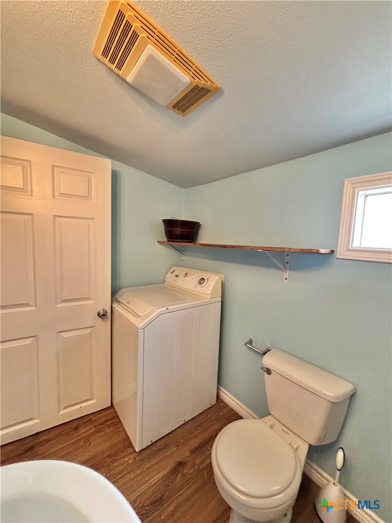 208 Washington Boulevard Port O'Connor, TX 77982 - Photo 39 of 47 a white toilet sitting next to a bathroom sink