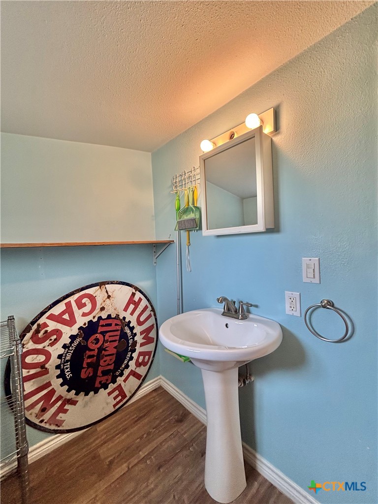 208 Washington Boulevard Port O'Connor, TX 77982 - Photo 40 of 47 a bathroom with a sink and a mirror