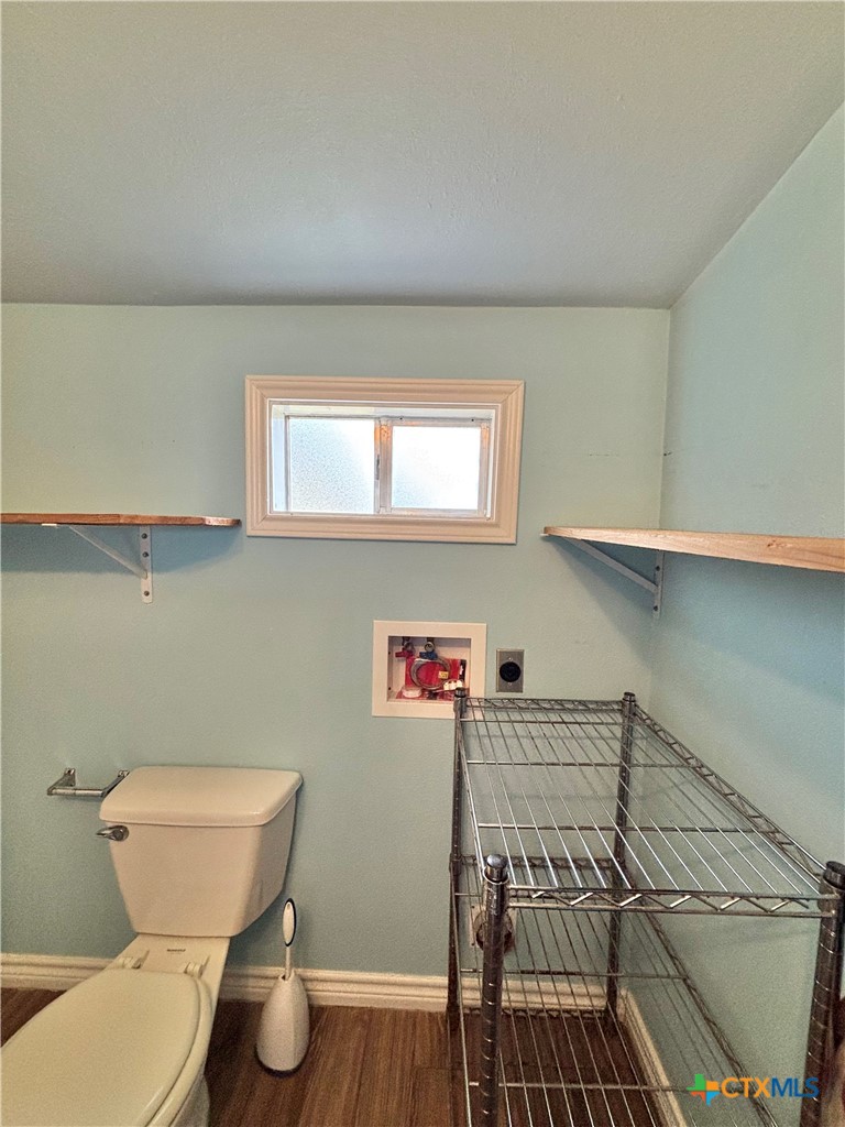 208 Washington Boulevard Port O'Connor, TX 77982 - Photo 41 of 47 a bathroom with a toilet a sink and a window