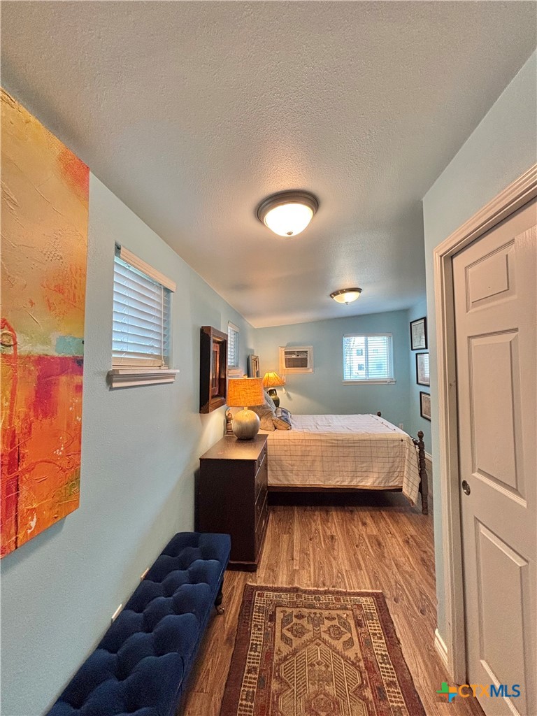 208 Washington Boulevard Port O'Connor, TX 77982 - Photo 42 of 47 a bedroom with a bed and wooden floor
