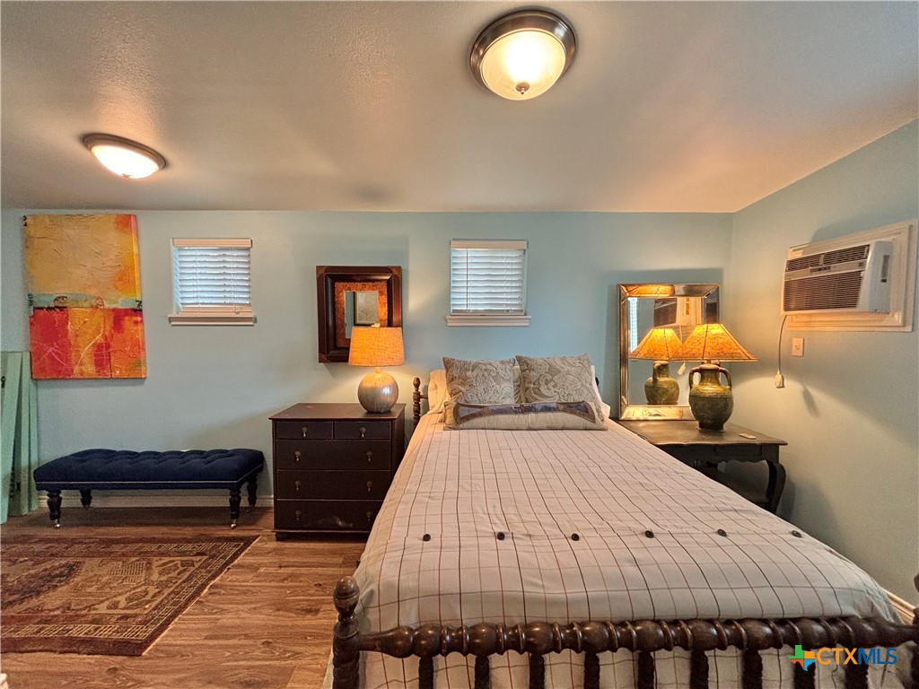 208 Washington Boulevard Port O'Connor, TX 77982 - Photo 43 of 47 a bed room with a bed and wooden floor