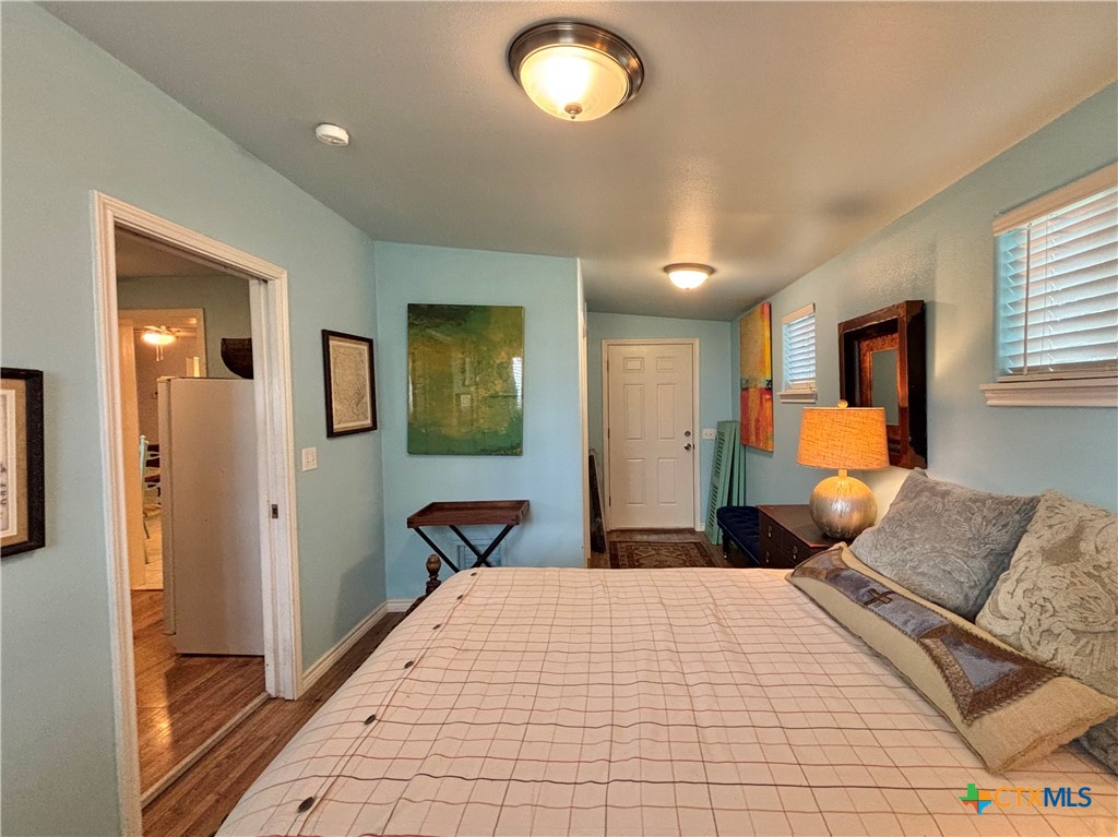 208 Washington Boulevard Port O'Connor, TX 77982 - Photo 45 of 47 a bedroom with a large bed and a chandelier
