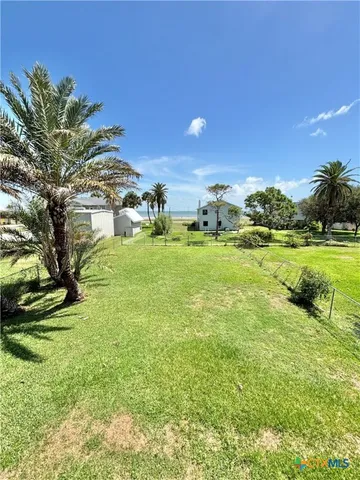 a view of a hallway with a refrigerator