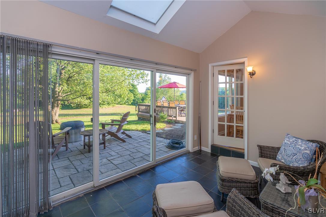 6774 Tollgate Road Zionsville, PA 18092 - Photo 12 of 25 Sunroom with vaulted ceilings and access to patio