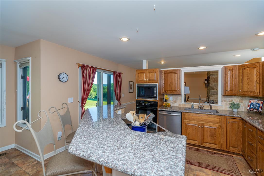 6774 Tollgate Road Zionsville, PA 18092 - Photo 9 of 25 Spacious kitchen with breakfast bar and dining are