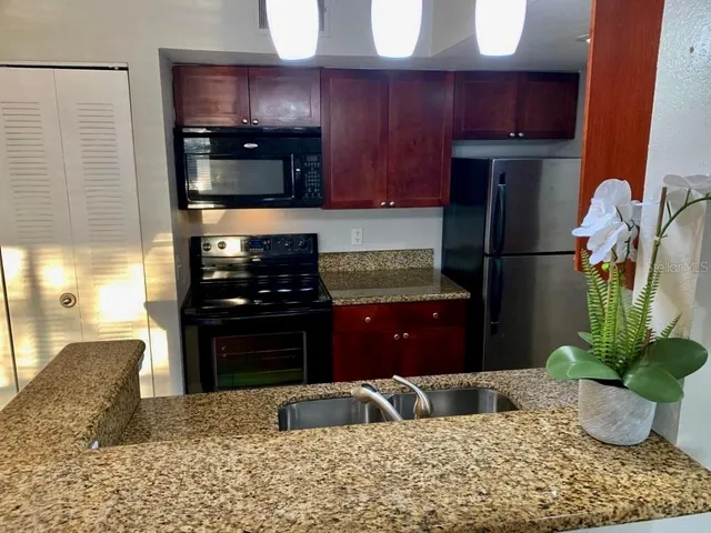 a kitchen with a refrigerator and a sink