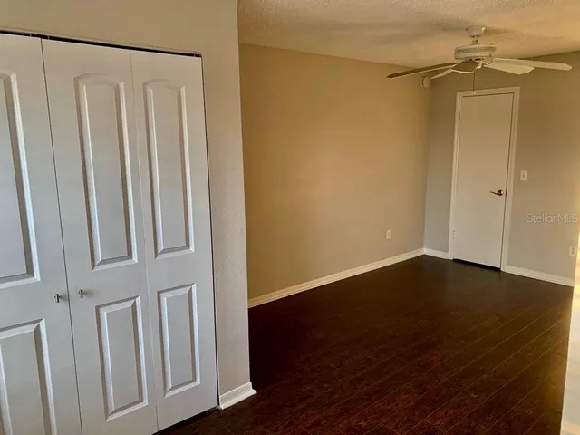 a view of a small space with wooden floor and a shower