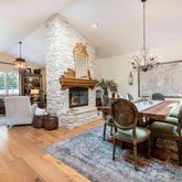 a living room with furniture dining table and a fireplace