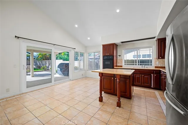 a kitchen with stainless steel appliances granite countertop a refrigerator stove and sink