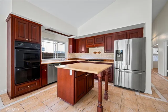 a kitchen with stainless steel appliances granite countertop a stove and a microwave