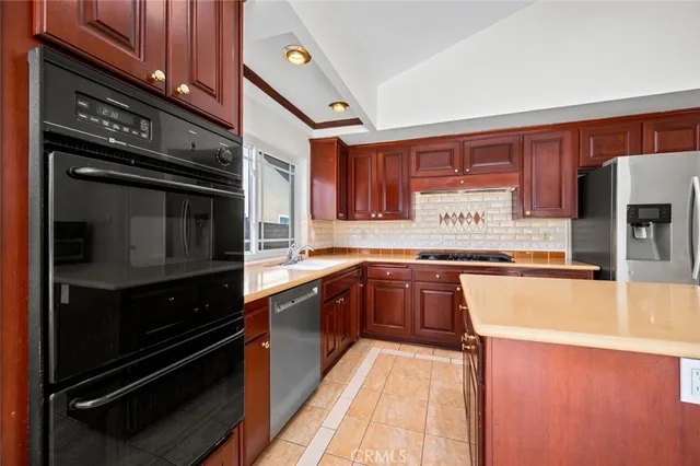 a kitchen with stainless steel appliances granite countertop a stove and a sink