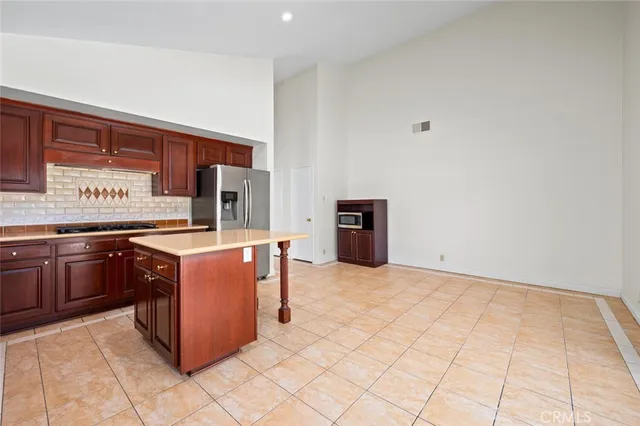 a kitchen with stainless steel appliances granite countertop a stove a refrigerator and a microwave