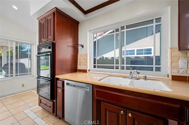 a kitchen with a wooden floor and a refrigerator