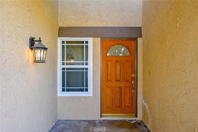 an empty room with mirror and a fireplace