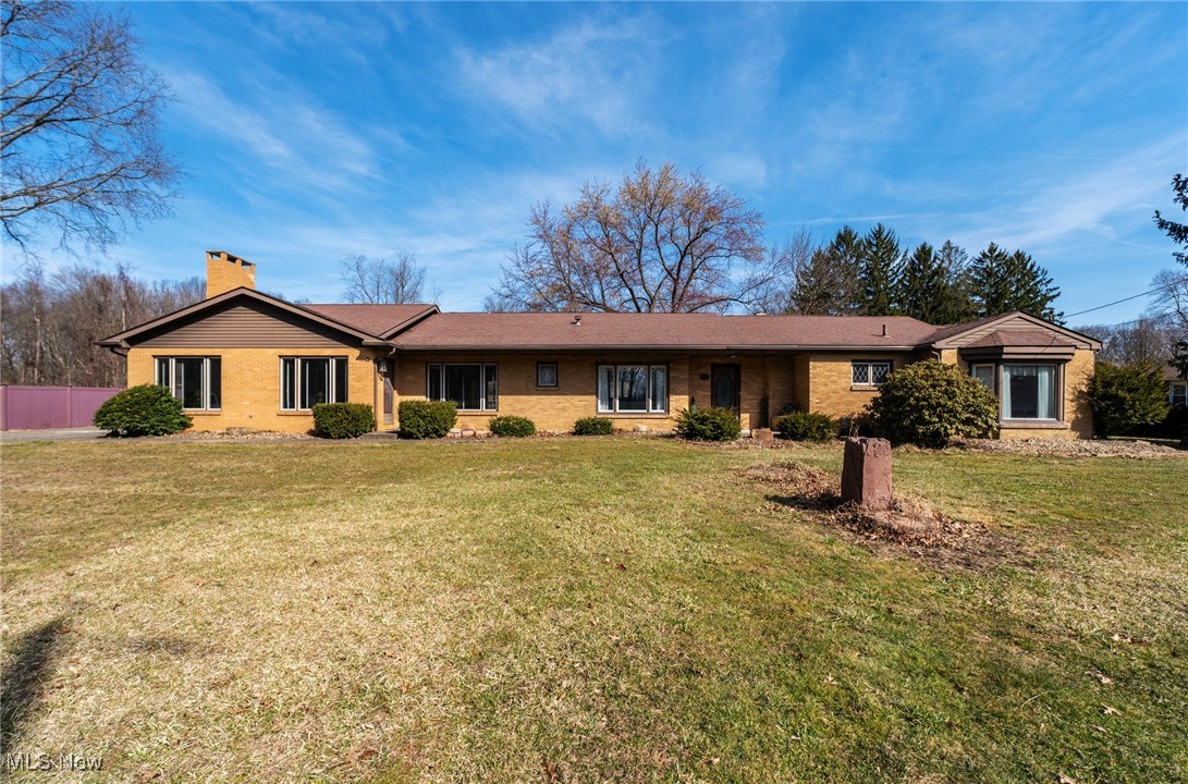 7059 Stewart Sharon Road Hubbard, OH 44425 - Photo 1 of 49 Ranch-style home featuring a chimney, a front lawn, and fence