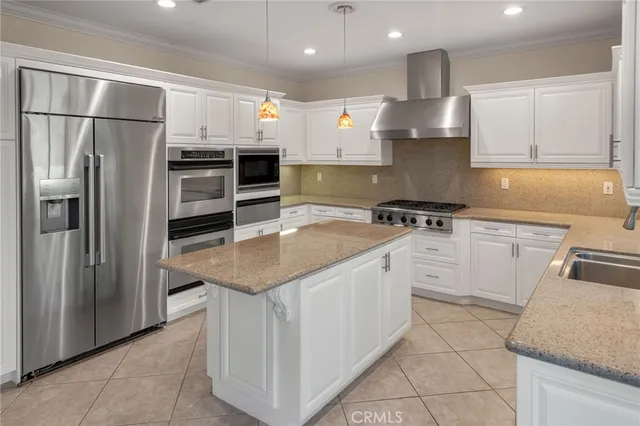 a kitchen with granite countertop a sink a stove and cabinets