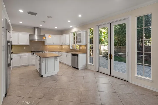 an empty room with windows and fireplace