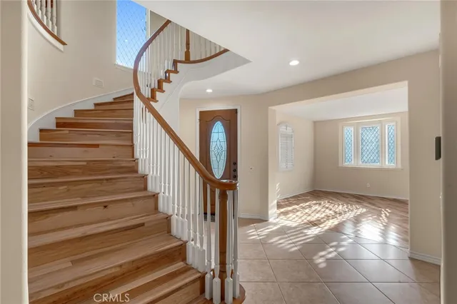 a view of entryway with wooden floor and stairs