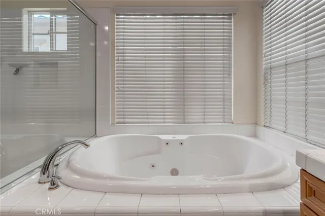 a bathroom with a bathtub and shower