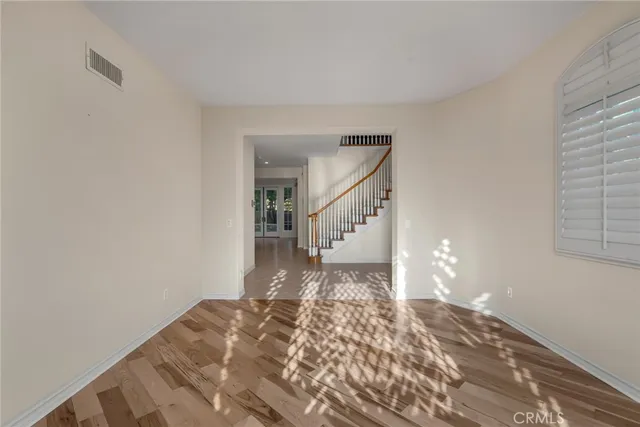 a view of a bedroom with wooden floor and a rug