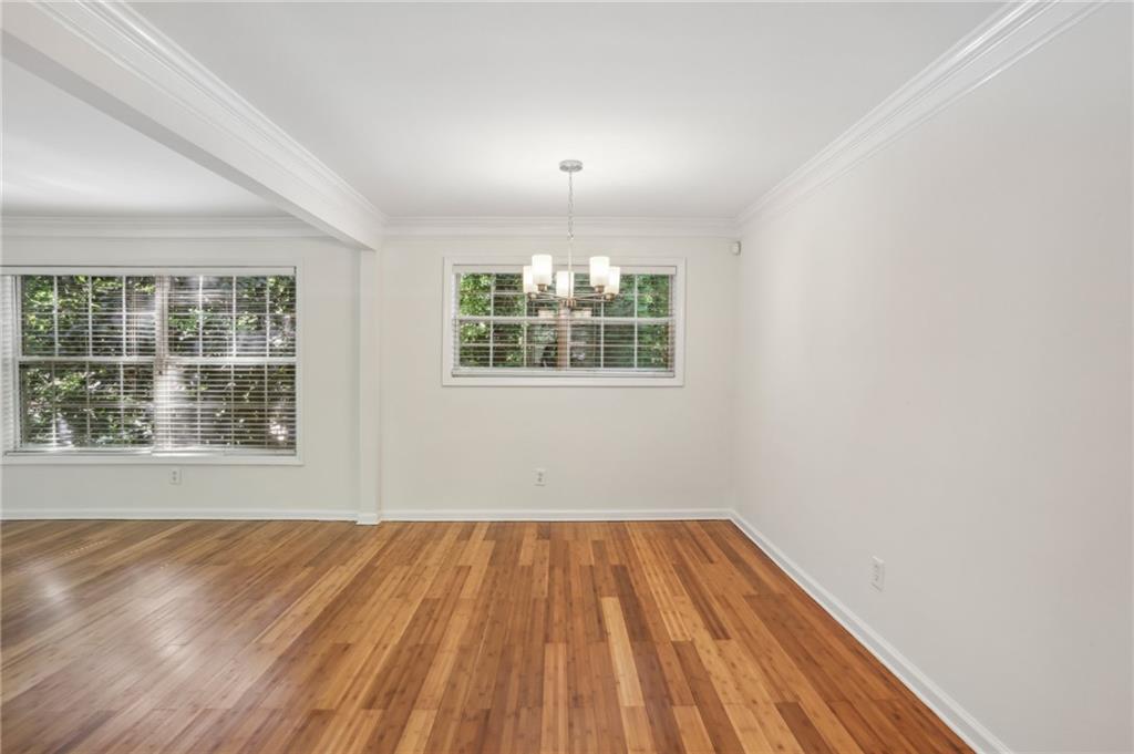 311 Peachtree Hills Avenue Northeast, Unit 13B Atlanta, GA 30305 - Photo 14 of 30 an empty room with wooden floor and windows