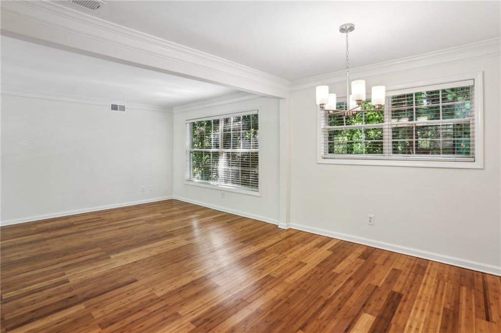 311 Peachtree Hills Avenue Northeast, Unit 13B Atlanta, GA 30305 - Photo 15 of 30 a view of an empty room with wooden floor and a window