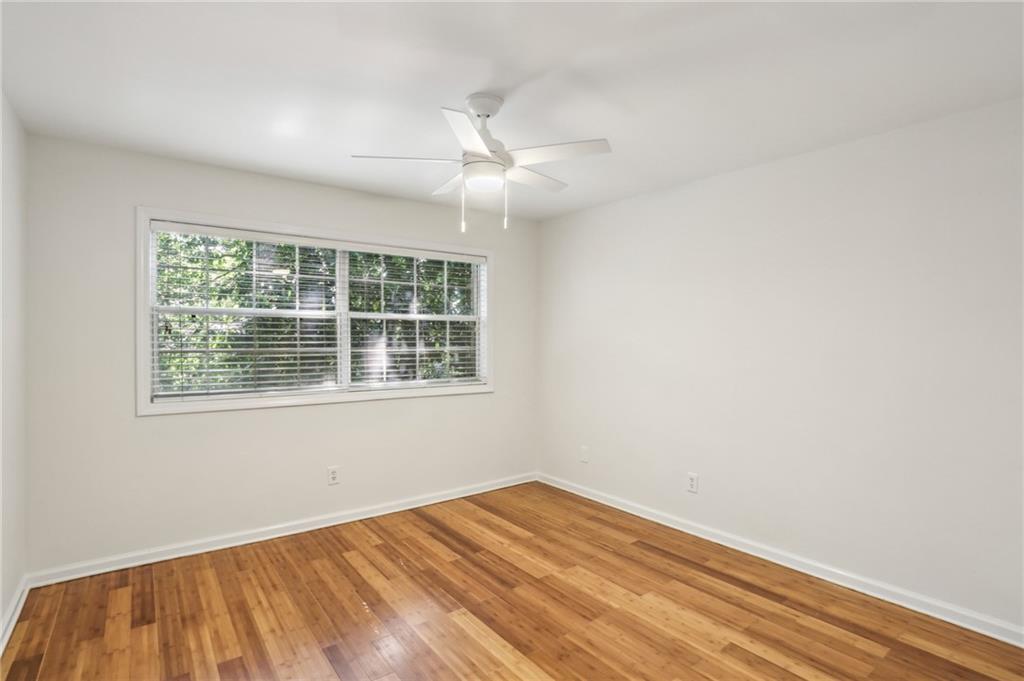 311 Peachtree Hills Avenue Northeast, Unit 13B Atlanta, GA 30305 - Photo 18 of 30 an empty room with a window and ceiling fan