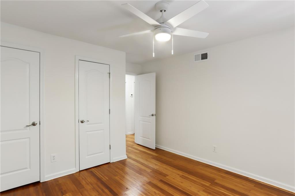 311 Peachtree Hills Avenue Northeast, Unit 13B Atlanta, GA 30305 - Photo 20 of 30 a view of an empty room with wooden floor