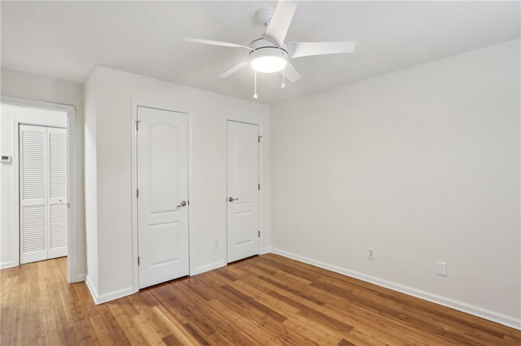 311 Peachtree Hills Avenue Northeast, Unit 13B Atlanta, GA 30305 - Photo 23 of 30 wooden floor in an empty room